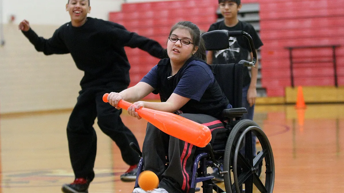Adaptive PE class with students in wheelchairs participating in sports